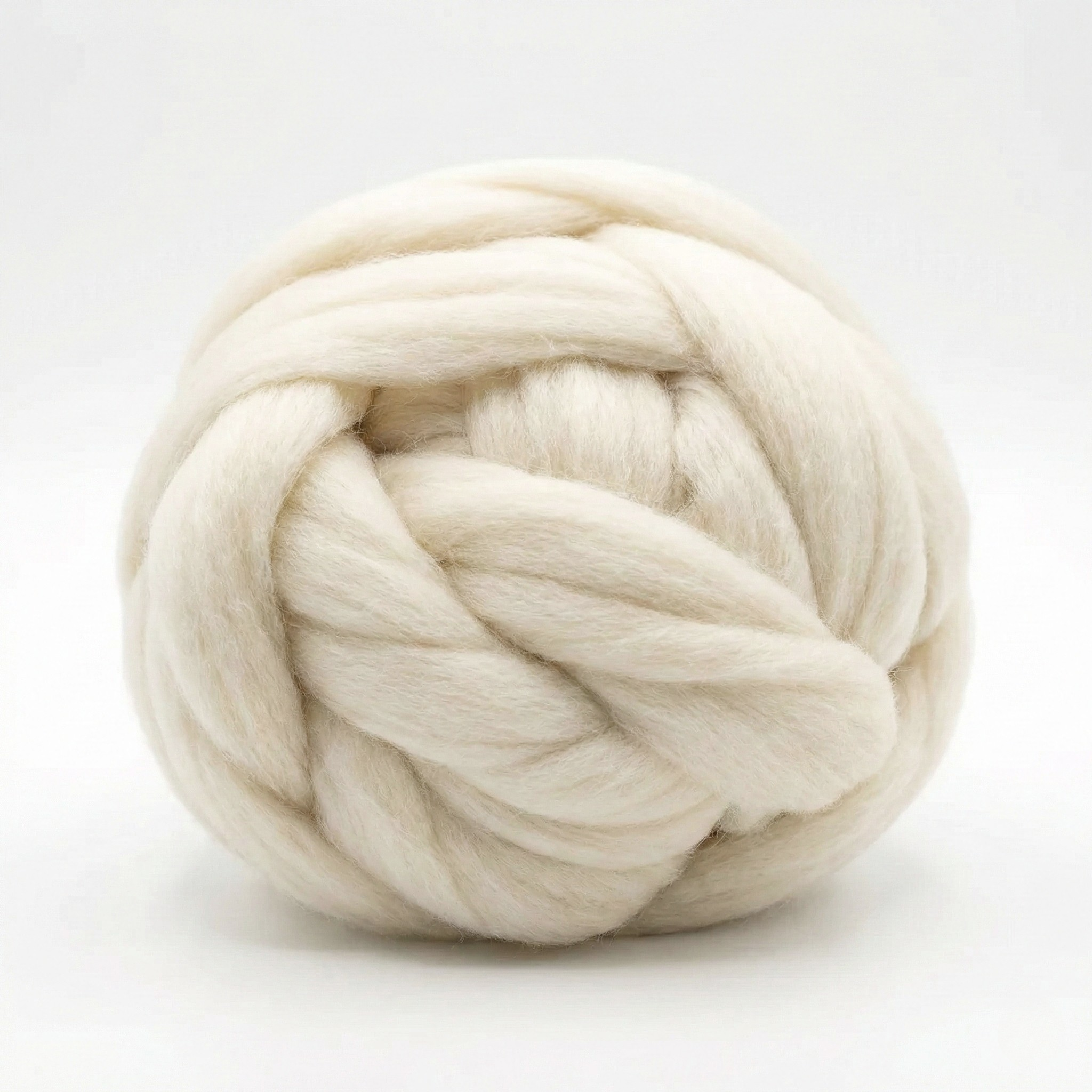 Revolution Fibers Cheviot combed wool top roving coiled ball on white background, angled to highlight loft and clean prep.