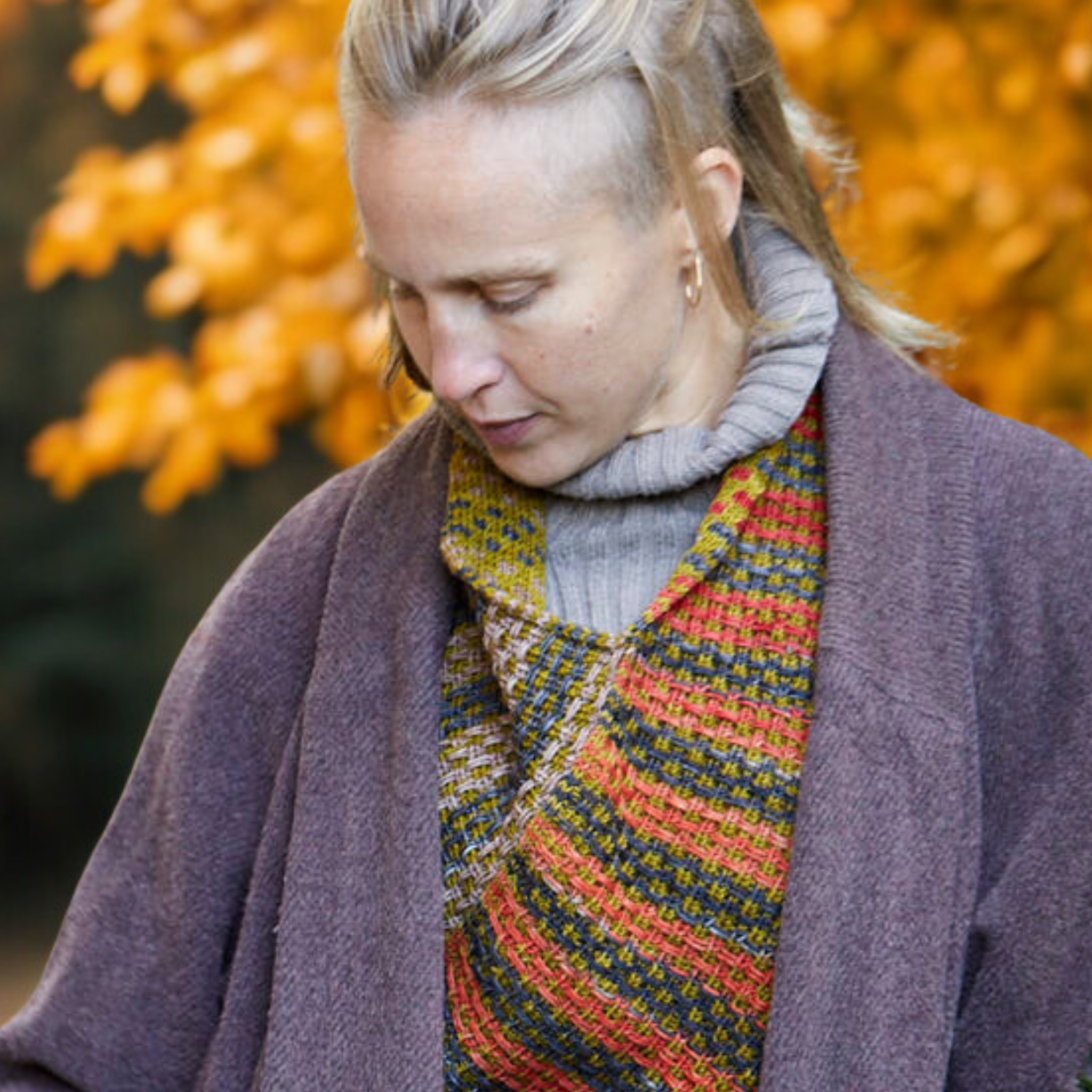 Close‑up of the Saman Cowl in Uneek 3021 and Harvest Fig draped on a model for a warm, autumn look.