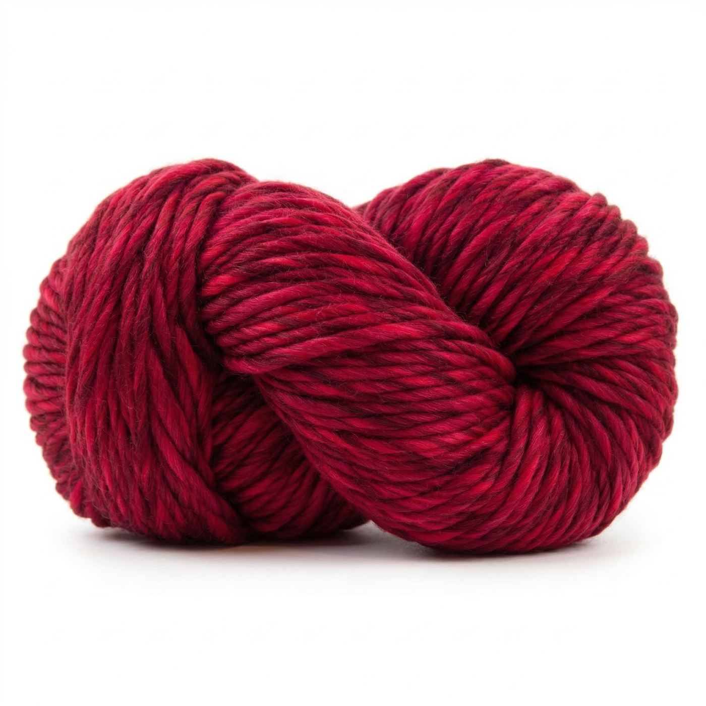 Passion Red super bulky multicolor merino wool yarn skein in a soft twisted pose on a light neutral background.