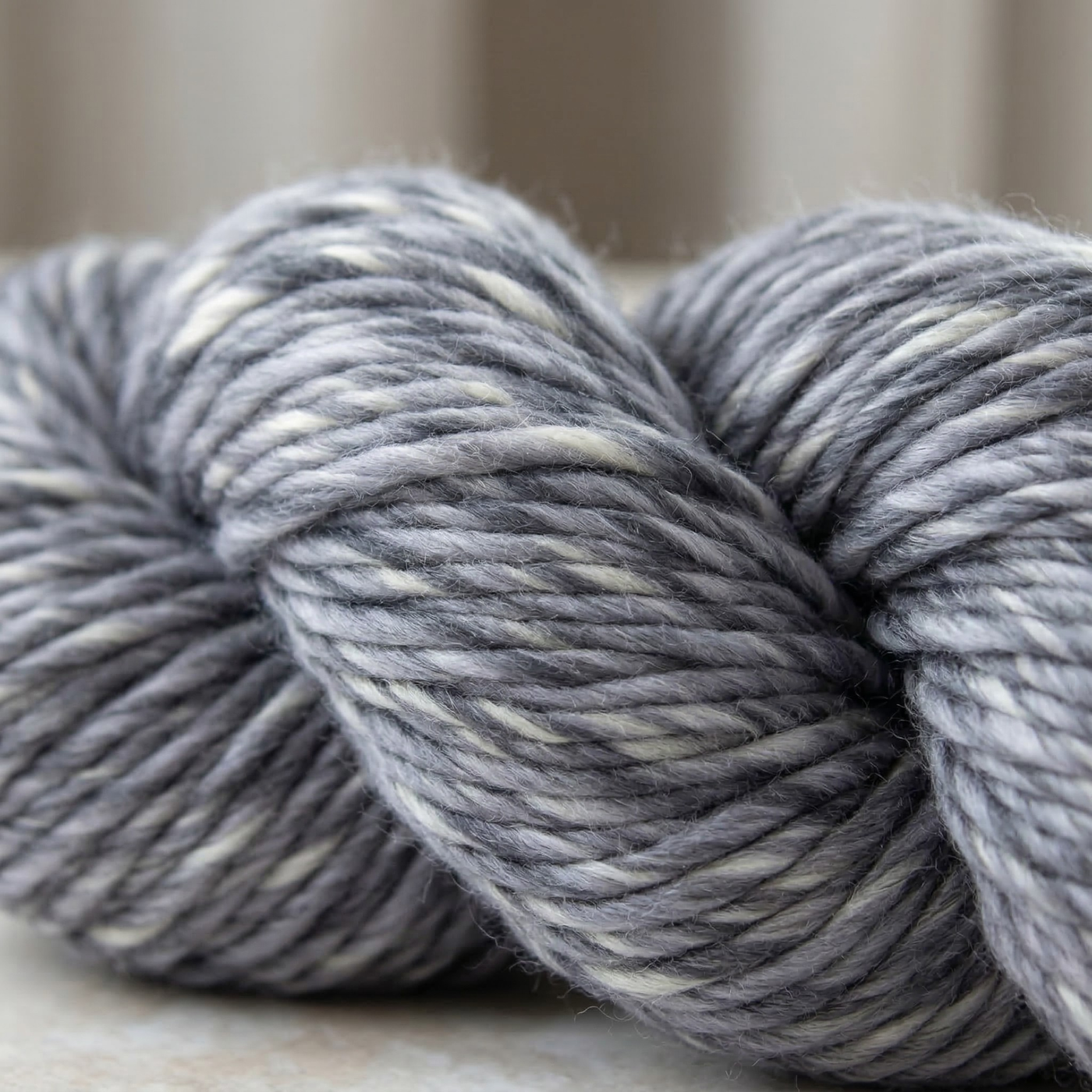Close-up macro of Tempest Gray super bulky multicolor merino wool yarn showing thick singles, marled color, and soft merino texture.